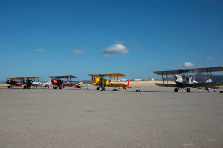 Crew members and biplanes prepare for the start of the Vintage Air Rally over the airport of Sitia on the island of Crete, Greece, November 11, 2016. Vintage Air Rally/Beatrice de Smet/Handout via REUTERS