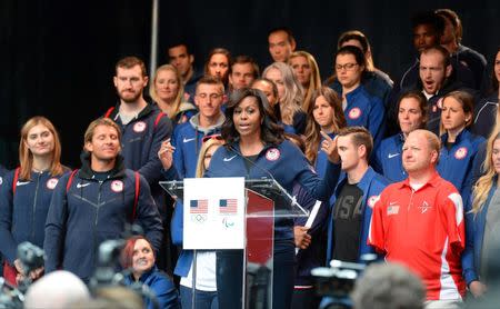 Apr 27, 2016; New York, NY, USA; First Lady Michelle Obama addresses the crowd while standing in front of U.S. athletes during the U.S. Olympic Committee 100 day countdown event to the Rio 2016 Games at Times Square. Mandatory Credit: Robert Deutsch-USA TODAY Sports