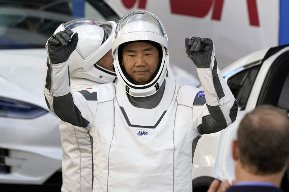 Japan Aerospace Exploration Agency astronaut Soichi Noguchi reacts as he leaves the Operations and Checkout Building with fellow crew members for a trip to Launch Pad 39-A and planned liftoff on a SpaceX Falcon 9 rocket with the Crew Dragon capsule on a six-month mission to the International Space Station Sunday, Nov. 15, 2020, at the Kennedy Space Center in Cape Canaveral, Fla. (AP Photo/John Raoux)
