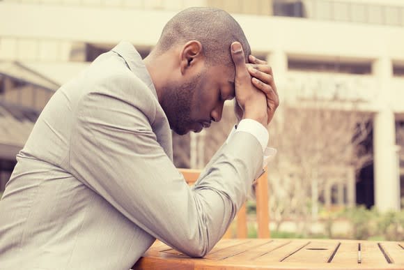 Man holding his head as if stressed