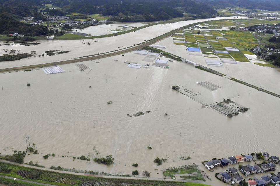 FILE - A town is flooded due to a heavy rain brought by Typhoon Nanmadol, in Kunitomi, Miyazaki prefecture, southern Japan, Sept. 19, 2022. The risk of typhoons in Japan has gone up and the amount of snowfall has declined, even as the threat of heavy snowfall remains. (Kyodo News via AP, File)
