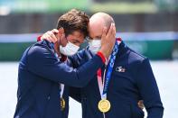 <p>Gold medallists France's Hugo Boucheron and Matthieu Androdias react on the podium following the men's double sculls final during the Tokyo 2020 Olympic Games at the Sea Forest Waterway in Tokyo on July 28, 2021. (Photo by Charly TRIBALLEAU / AFP)</p> 