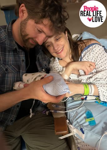 <p>Northwell Health</p> From left, Michael Odland holds son Reggie with wife Nora