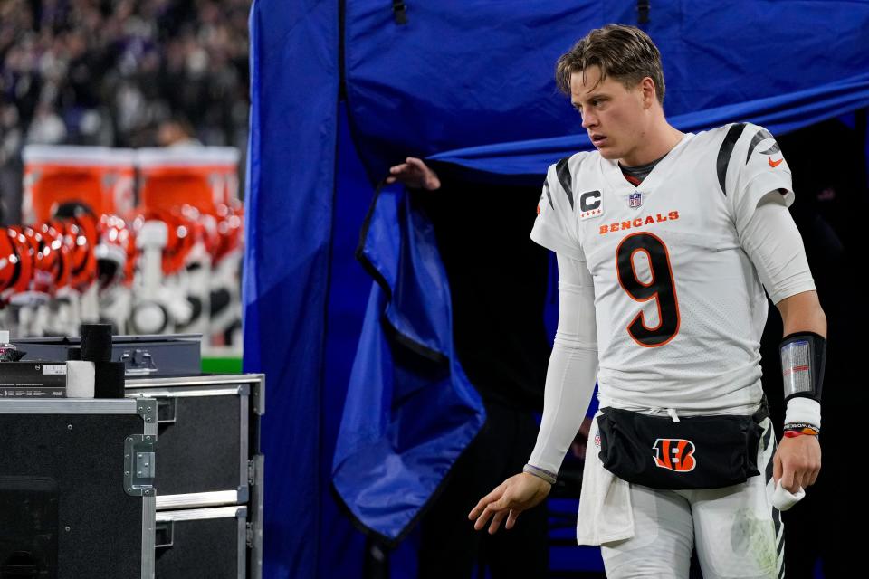 Cincinnati Bengals quarterback Joe Burrow emerges from the examination tent before running to the locker room with a wrist injury. He has been ruled out for the season with a torn ligament.
