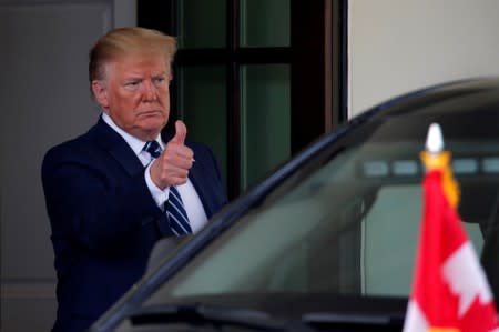 FILE PHOTO: U.S. President Donald Trump gives a thumbs-up to Canada's Prime Minister Justin Trudeau, as he leaves after a meeting at the Oval Office of the White House in Washington, U.S.