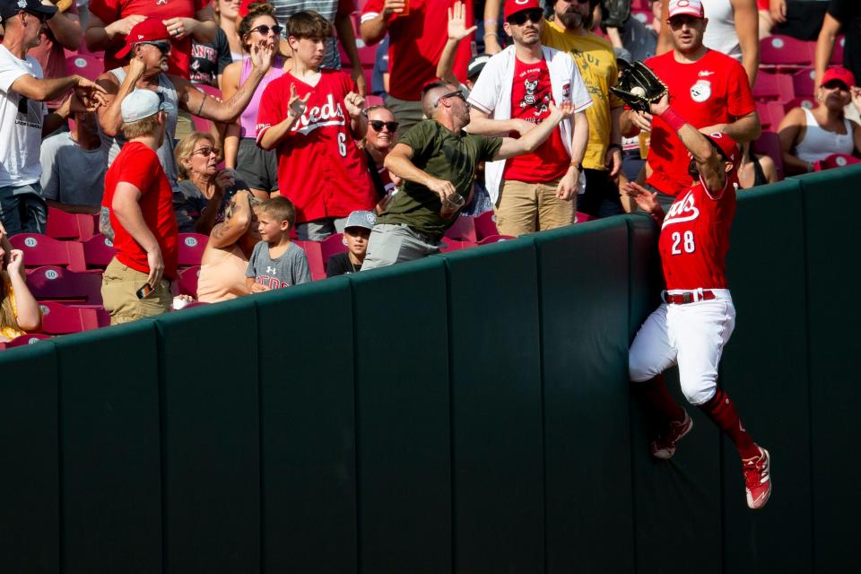 Cincinnati Reds left fielder Tommy Pham (28) catches a ball at the wall in the fifth inning of the MLB game between the Cincinnati Reds and the Atlanta Braves at Great American Ball Park in Cincinnati on Saturday, July 2, 2022.