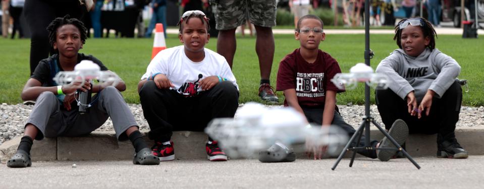 (L to R) Tolan Kyle, 11, Brayden Bradley, 10, Richard Kiel, 10 and Marlon Wilson, 11 watch as small programmed drones perform in front of them during youth drone demo day put on by Code 313 in front of Ford’s Michigan Central Station in Detroit on Saturday, September 9, 2023.