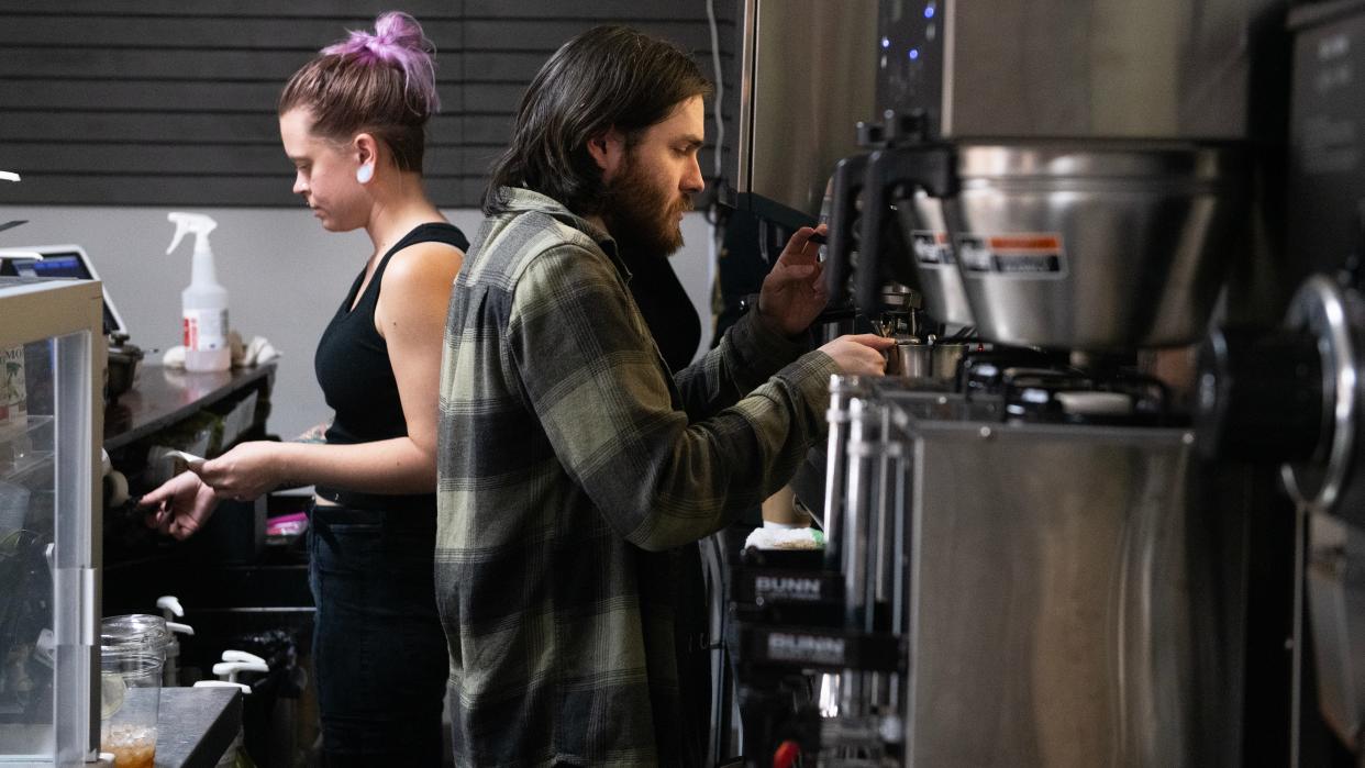 Baristas Mike Day of Blackwood, right, and Grace Christensen of Mullica Hill prepare beverages at Daily Grounds coffee shop in Wenonah on Friday, December 1, 2023.