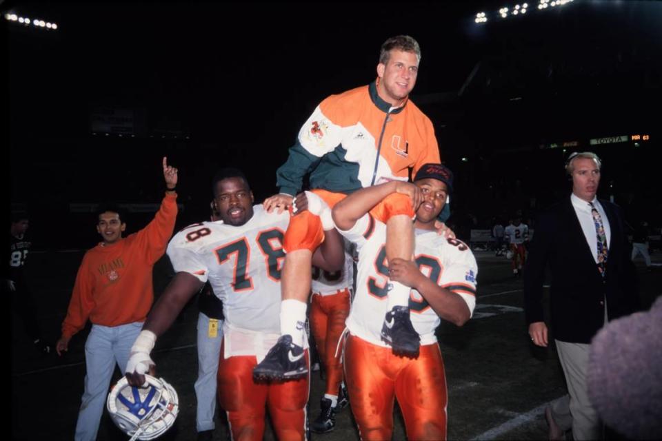 1992 Miami Hurricanes Football: UM quarterback Gino Torretta is hoisted on the shoulders of teammates Kipp Vickers (78) and Mark Caesar (99) after the final regular-season game at San Diego State University.