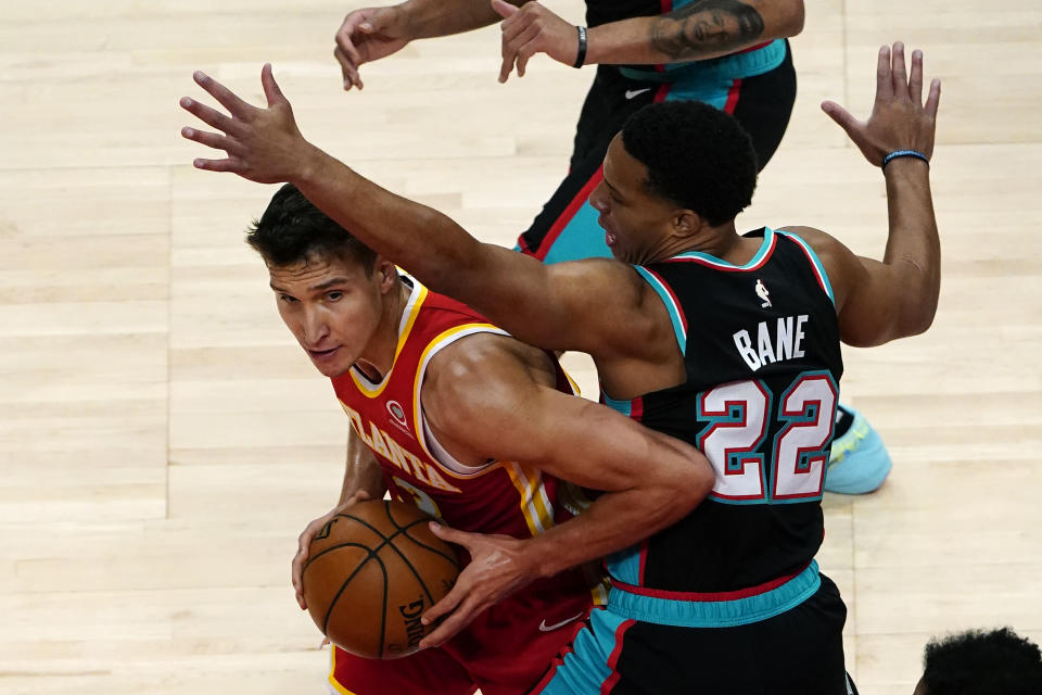 Atlanta Hawks guard Bogdan Bogdanovic (13) tries to get around Memphis Grizzlies guard Desmond Bane (22) in the first half of an NBA basketball game Wednesday, April 7, 2021, in Atlanta. (AP Photo/John Bazemore)