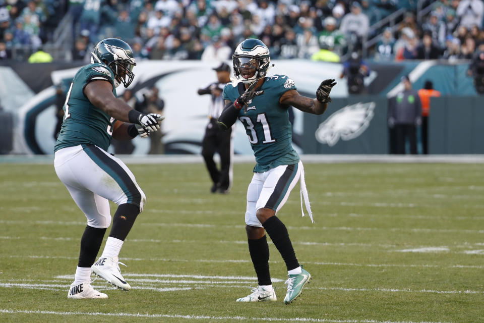 Philadelphia Eagles’ Jalen Mills, right, and Fletcher Cox celebrate after a sack against the Bears. (AP)