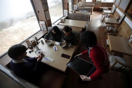 Customers sit at KiriKiri Zembei restaurant, in KiriKiri town, Iwate prefecture March 27, 2011. REUTERS/Carlos Barria