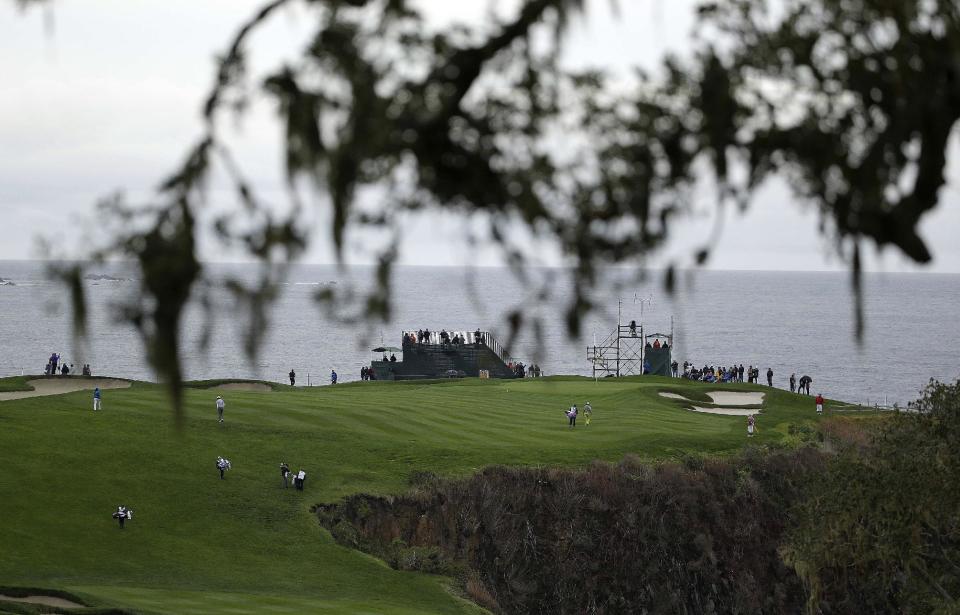 The playing group of Aaron Baddeley, Kenny G, Lucas Glover and Tom Dreesen make their way up to the sixth green of the Pebble Beach Golf Links during the second round of the AT&T Pebble Beach Pro-Am golf tournament on Friday, Feb. 7, 2014, in Pebble Beach, Calif. (AP Photo/Eric Risberg)