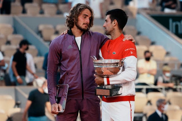 Novak Djokovic, right, and Stefanos Tsitsipas share a moment on the podium