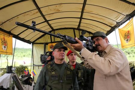 Venezuela's President Nicolas Maduro (R) takes part in a military drill in Charallave, Venezuela January 14, 2017. Miraflores Palace/Handout via REUTERS