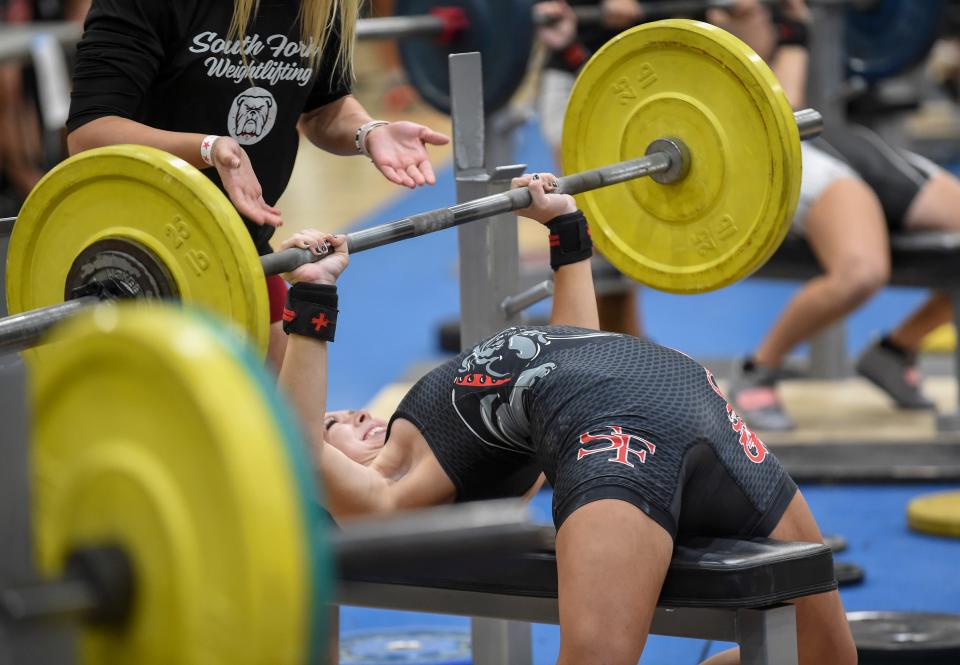 Ashley Anderson, of South Fork High School, struggles with bench pressing 110 pounds in the 129 pound class during the Girls Weight Lifting Class 2A District 16 meet on Friday, Jan. 21, 2022, at Jensen Beach High School. 