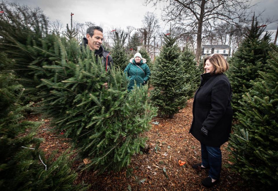 John Rodrigues, whose family has owned Tony's Nursery in Larchmont for over 100 years, helps Kathleen Hannon of Scarsdale and her daughter Tara select a Christmas tree Dec. 11, 2023. Rodrigues says that the nursery will sell several thousand Fraser Fir trees during the holiday season. All his trees come from either Canada or North Carolina.