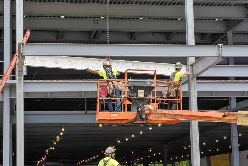 Workers from Waynesboro Construction fit the last steel beam into place for Hagerstown's new field house, under construction on the site of the former Municipal Stadium.