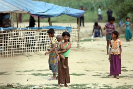 Rohingya people who fled from their towns after the violence in the state of Rakhine, are seen behind a fence on the border line outside Maungdaw, Myanmar March 31, 2018. Picture taken March 31, 2018. REUTERS/Stringer