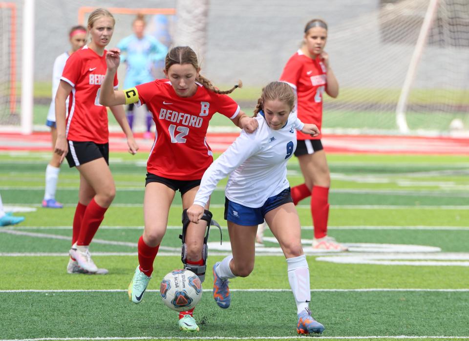 Bedford captain Bre Boros (12) playing for the first time since suffering a knee injury last season battles for the ball with Josi Farago of Gibraltar Carlson on Saturday, May 11, 2024. The teams played to a 1-1 tie.