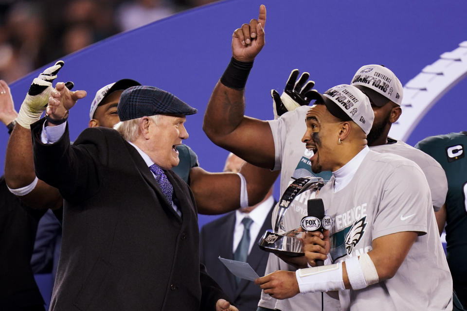 Terry Bradshaw, left, reacts with Philadelphia Eagles quarterback Jalen Hurts, right, after the NFC Championship NFL football game between the Philadelphia Eagles and the San Francisco 49ers on Sunday, Jan. 29, 2023, in Philadelphia. The Eagles won 31-7. (AP Photo/Seth Wenig)