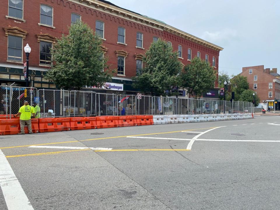 Construction crews install a barrier and fencing at the Union Block property on July 19, 2023, one week prior to the discovery of structural issues inside the top floors of the building prompting the closure of businesses on the first floor.