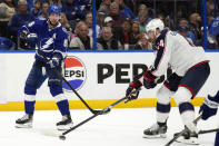 Tampa Bay Lightning right wing Nikita Kucherov (86) flips the puck past Columbus Blue Jackets defenseman Erik Gudbranson (44) during the second period of an NHL hockey game Tuesday, April 9, 2024, in Tampa, Fla. (AP Photo/Chris O'Meara)