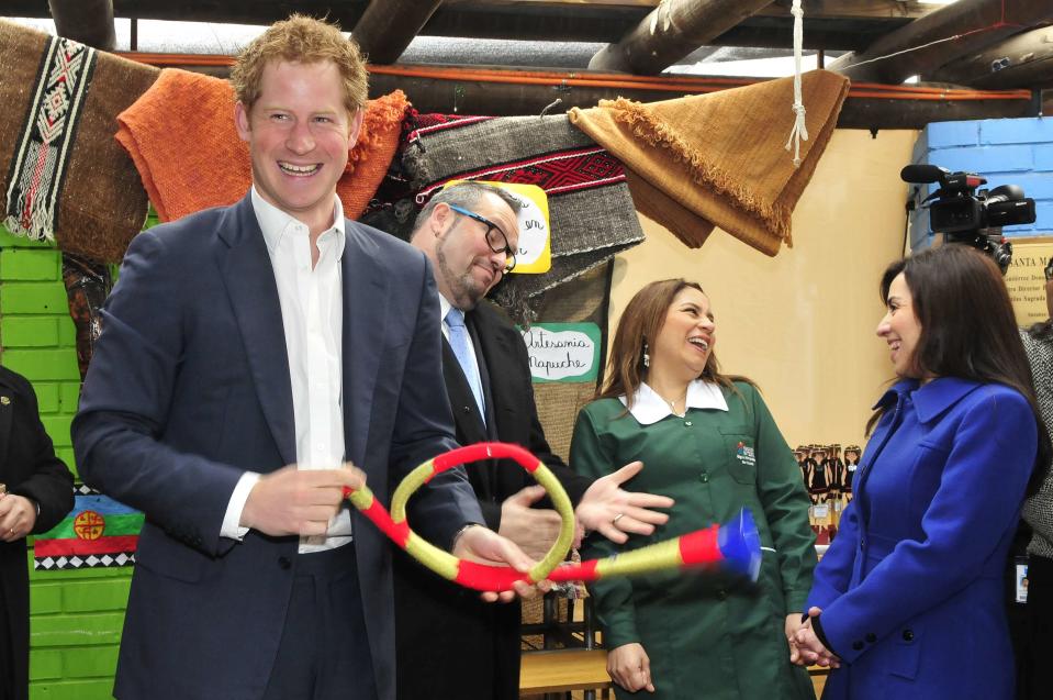 Britain's Prince Harry holds a plastic "trutruca" during a visit to Integra Foundation in Santiago