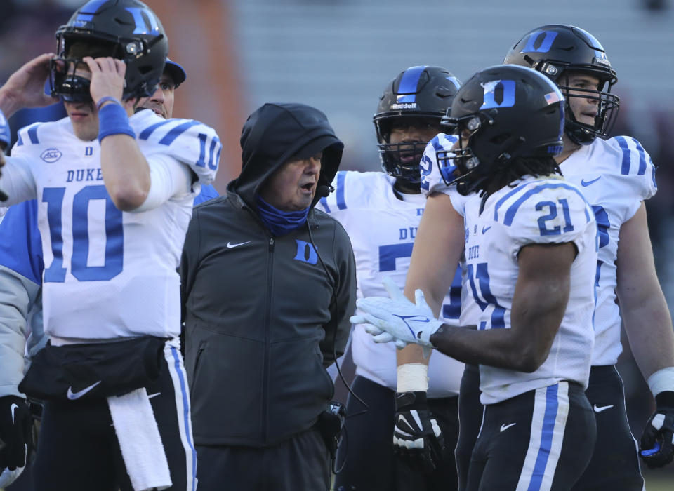 Duke coach David Cutcliffe huddles with his offensive unit during a timeout against Virginia Tech in the first half of an NCAA college football game in Blacksburg Va., Saturday, Nov. 13 2021. (Matt Gentry/The Roanoke Times via AP)