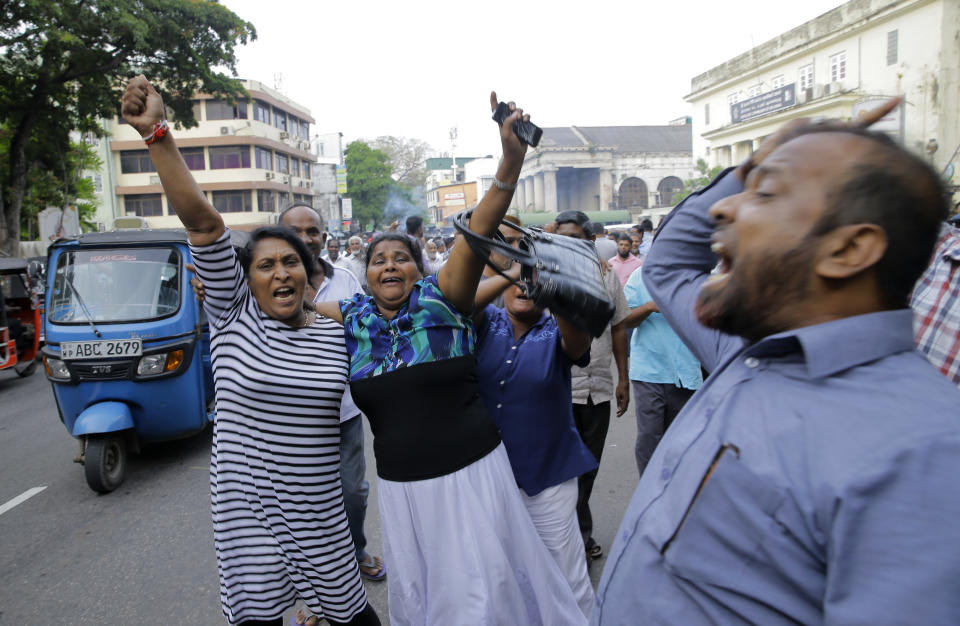 Supporters of ousted Sri Lankan Prime Minister Ranil Wickremesinghe celebrate outside the supreme court complex in Colombo, Sri Lanka, Thursday, Dec. 13, 2018. Sri Lanka's Supreme Court unanimously ruled as unconstitutional President Maithripala Sirisena's order to dissolve Parliament and call for fresh elections, a much-anticipated verdict Thursday that further embroils the Indian Ocean island nation in political crisis.(AP Photo/Eranga Jayawardena)