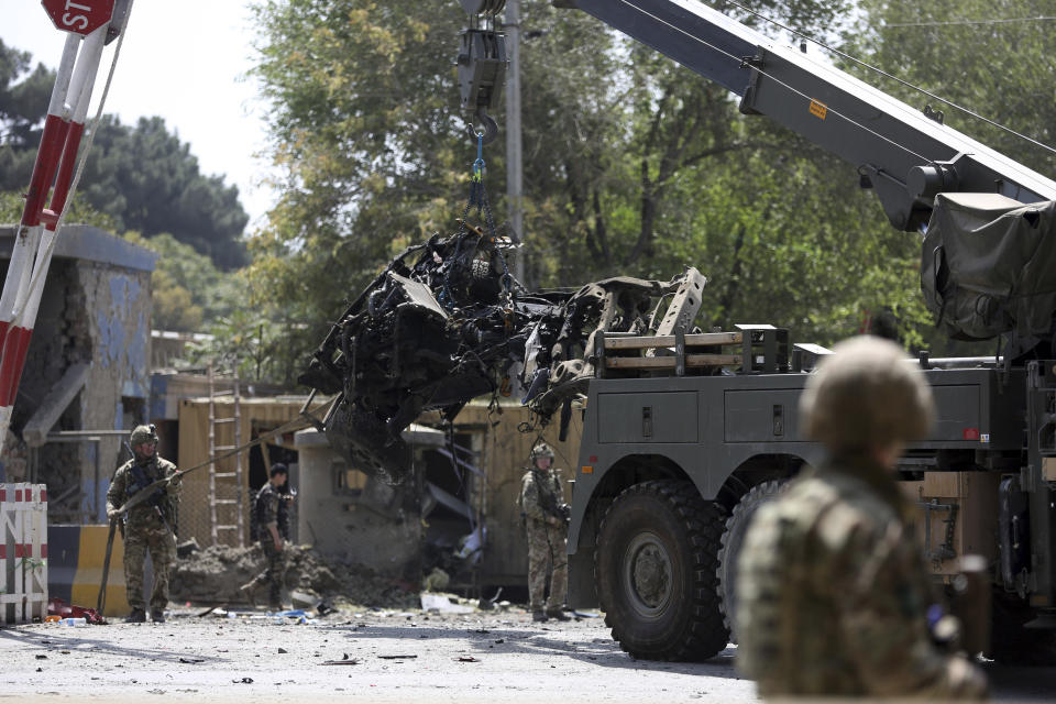 Resolute Support (RS) forces remove a damaged vehicle after a car bomb explosion in Kabul, Afghanistan, Thursday, Sept. 5, 2019. A car bomb rocked the Afghan capital on Thursday and smoke rose from a part of eastern Kabul near a neighborhood housing the U.S. Embassy, the NATO Resolute Support mission and other diplomatic missions. (AP Photo/Rahmat Gul)