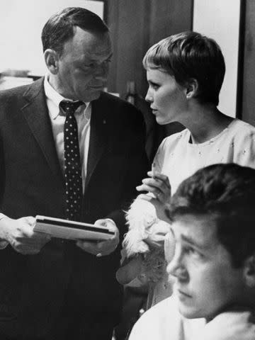 <p>Keystone Features/Getty </p> Frank Sinatra and Mia Farrow during a break in a recording session at Hollywood's Sunset Boulevard recording studio.