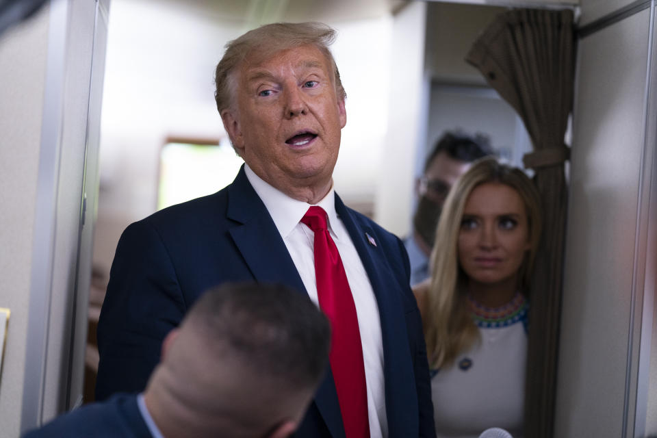 President Donald Trump talks with reporters after leaving a campaign rally at Pensacola International Airport, Friday, Oct. 23, 2020, aboard Air Force One. (AP Photo/Evan Vucci)