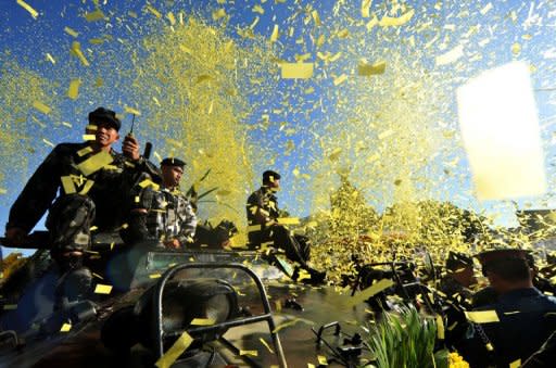 Philippine soldiers on an armoured personnel carrier take part on February 25 in a Manila re-enactment of events leading to the fall of the dictatorship of Ferdinand Marcos. The Philippines said Saturday it will auction off two properties once owned by the late dictator for at least 315.8 million pesos ($7.3 million)