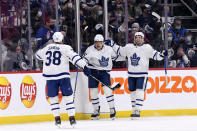 Toronto Maple Leafs' Ondrej Kase (25) celebrates his goal against the Winnipeg Jets with Rasmus Sandin (38) and Alexander Kerfoot (15) during the second period of NHL hockey game action in Winnipeg, Manitoba, Sunday, Dec. 5, 2021. (Fred Greenslade/The Canadian Press via AP)