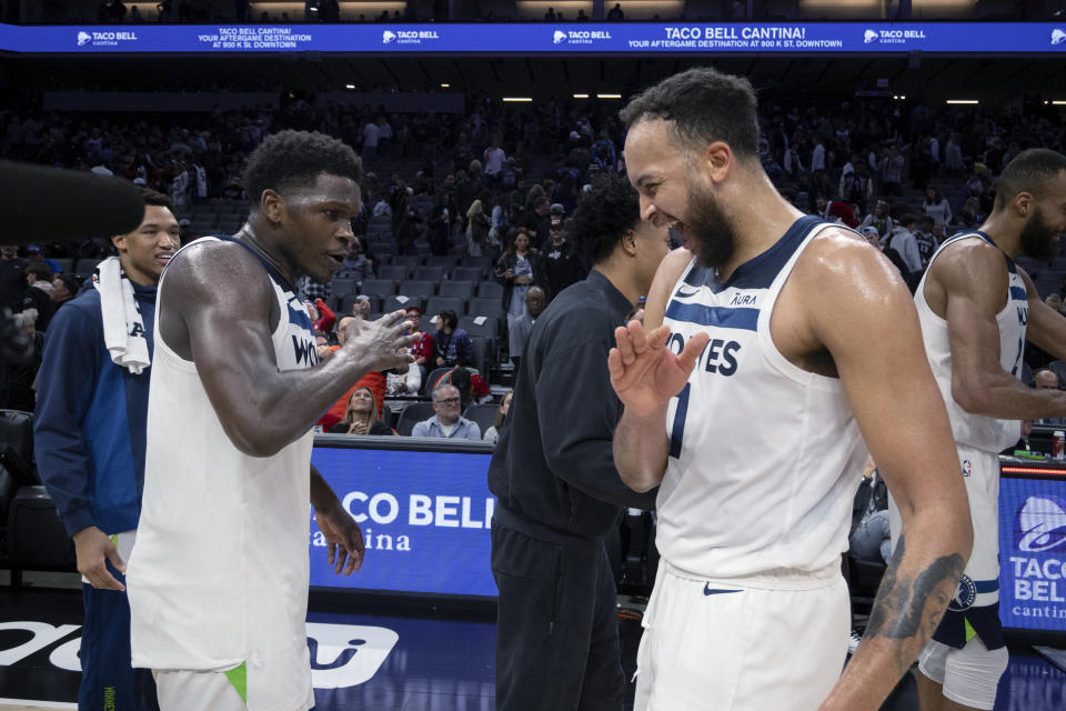 Minnesota Timberwolves guard Anthony Edwards, left celebrates with forward Kyle Anderson (1) following the team's 110-98 win over the Sacramento Kings in an NBA basketball game in Sacramento, Calif., Saturday, Dec. 23, 2023. (AP Photo/José Luis Villegas)