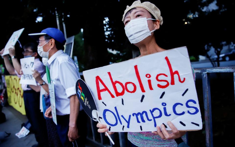 Anti-Olympics protestors gather in front of the Japanese prime minister's office amid news of Tokyo's record high Covid-19 cases on 29 July 2021 - Androniki Christodoulou/Reuters