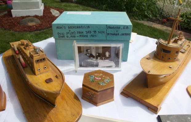 A box of letters and wooden boats and boxes carved by her father while he was interned in Petawawa, Ont., are displayed at Joan Vistarchi's Montreal home. After working during the day, interned Italian-Canadians would sing and carve wooden objects.