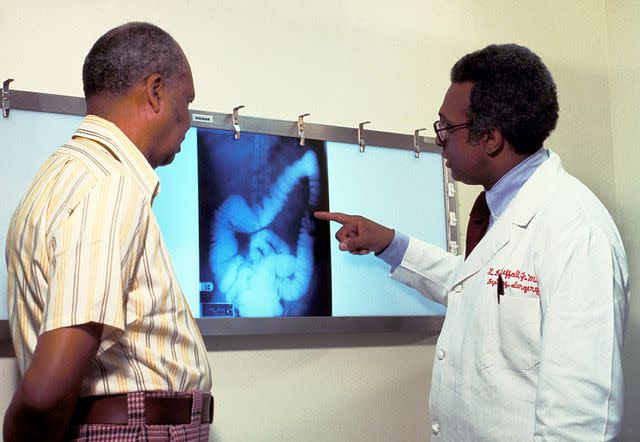 Getty Images North America A doctor goes over a patient''s x-ray, screening for colon cancer.