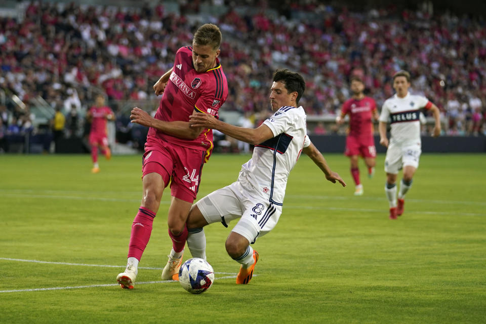 Vancouver Whitecaps' Alessandro Schopf (8) and St. Louis City's Lucas Bartlett (24) battle for the ball during the first half of an MLS soccer match Saturday, May 27, 2023, in St. Louis. (AP Photo/Jeff Roberson)