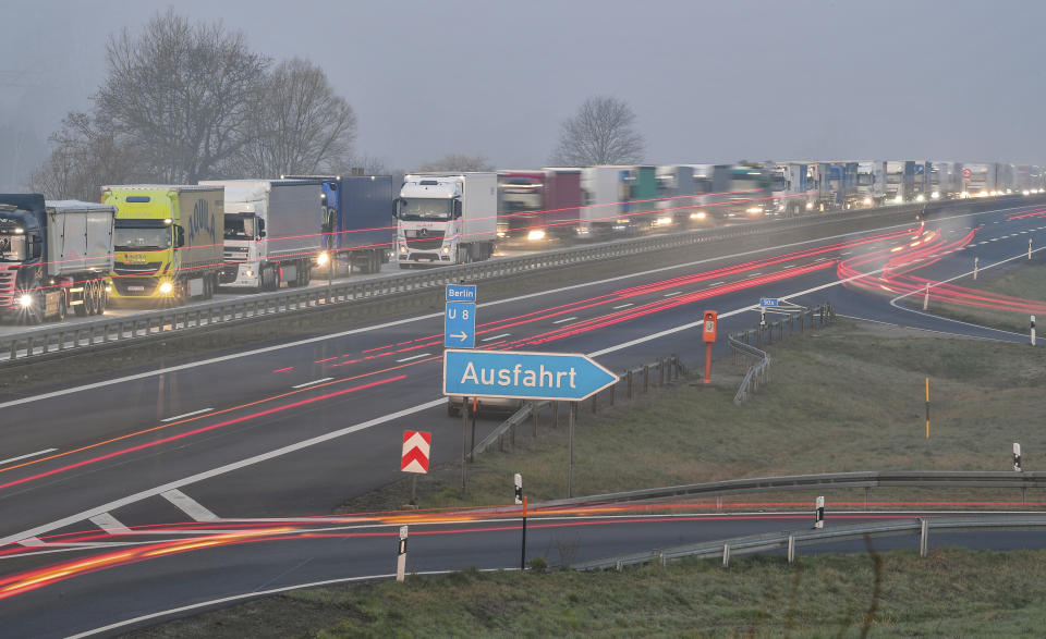 Trucks are jammed in the early morning on Autobahn 12 in front of the German-Polish border crossing near Frankfurt (Oder), Germany, Wednesday, March 18, 2020. In order to make it more difficult for the corona virus to spread, Poland had reintroduced controls at the border crossings to Germany. For most people, the new coronavirus causes only mild or moderate symptoms, such as fever and cough. For some, especially older adults and people with existing health problems, it can cause more severe illness, including pneumonia. (Patrick Pleul/dpa via AP)