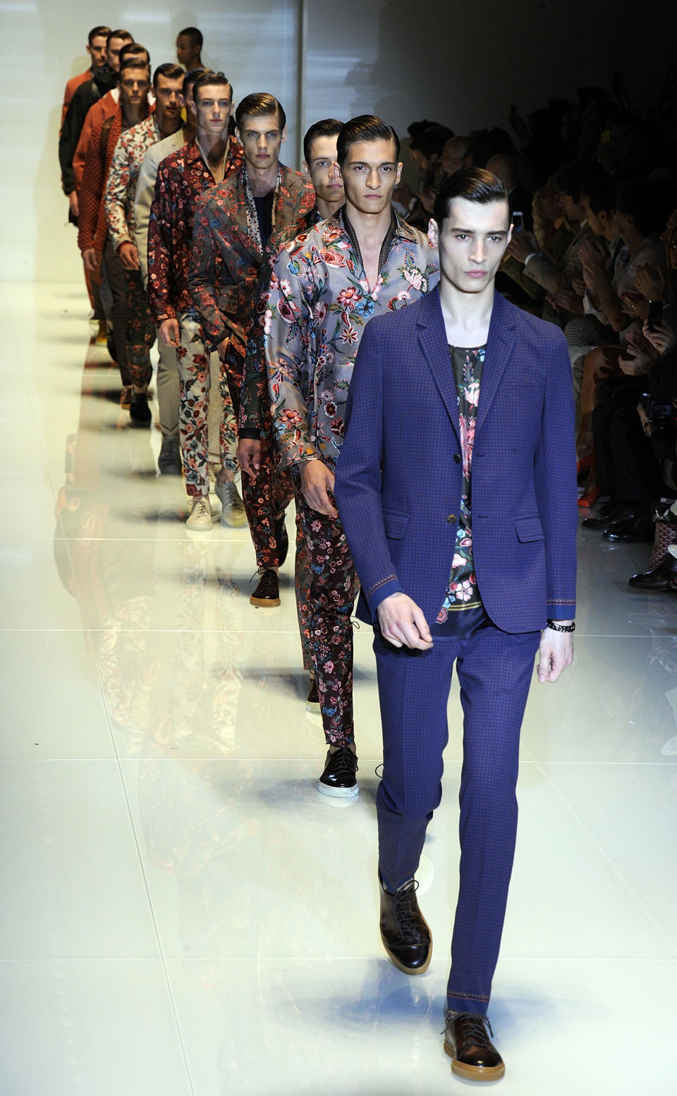 Models take the catwalk for the final exit at the Gucci men's Spring-Summer 2014 collection, part of the Milan Fashion Week, unveiled in Milan, Italy, Monday, June 24, 2013. (AP Photo/Giuseppe Aresu)