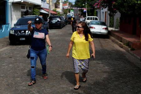 Sisters Emily and Isilda Hernandez walk to their house in Intipuca, El Salvador, August 14, 2018. REUTERS/Jose Cabezas