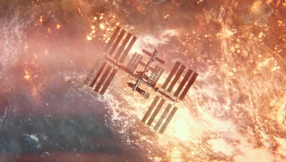 top-down view of a space station over earth, with fires and explosions visible on the planet's surface.