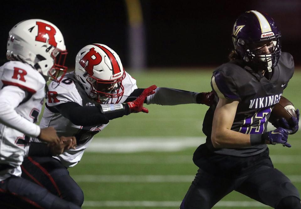 Renton's G'Mir Green (6) makes grab for North Kitsap's Jaxson Gore (13) on Friday, Nov. 4, 2022.