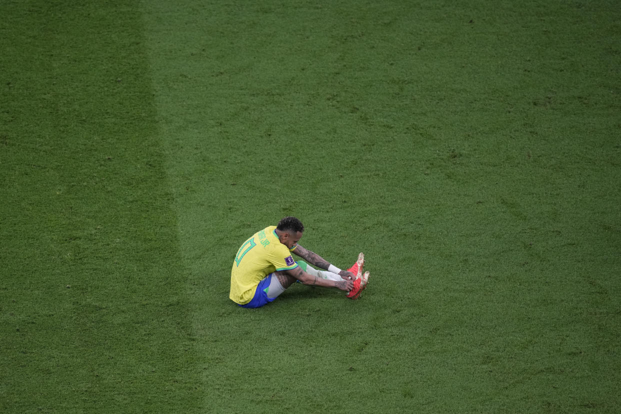 Brazil's Neymar, lies on the pitch during the World Cup group G soccer match between Brazil and Serbia, at the the Lusail Stadium in Lusail, Qatar on Thursday, Nov. 24, 2022. (AP Photo/Darko Vojinovic)
