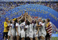 United States' team celebrates with trophy after winning the Women's World Cup final soccer match between US and The Netherlands at the Stade de Lyon in Decines, outside Lyon, France, Sunday, July 7, 2019. (AP Photo/Alessandra Tarantino)