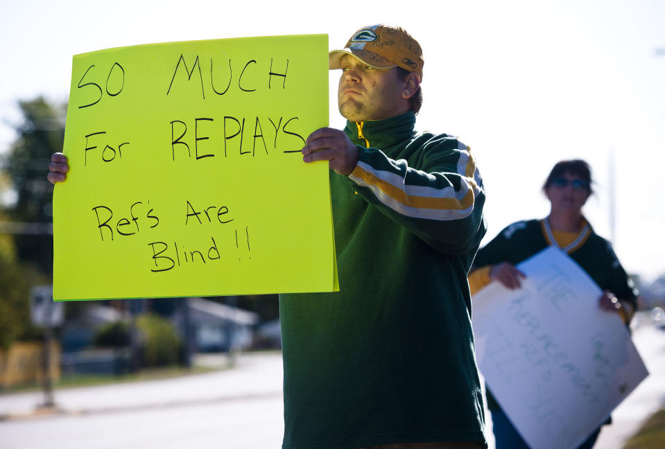 Green Bay Packers fan Mike LePak holds a sign Tuesday, Sept. 25, 2012 on Lombardi Avenue in Green Bay, Wisc., in protest of a controversial call in the Packers 14-12 loss to the Seattle Seahawks, Monday night in Seattle. Just when it seemed that NFL coaches, players and fans couldn't get any angrier, along came a fiasco that trumped any of the complaints from the weekend. (AP Photo/The Green Bay Press-Gazette, Lukas Keapproth ) NO SALES