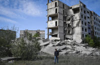 A local resident walks next to a house destroyed in a Russian shelling in Kramatorsk, Ukraine, Wednesday, May 25, 2022. (AP Photo/Andriy Andriyenko)