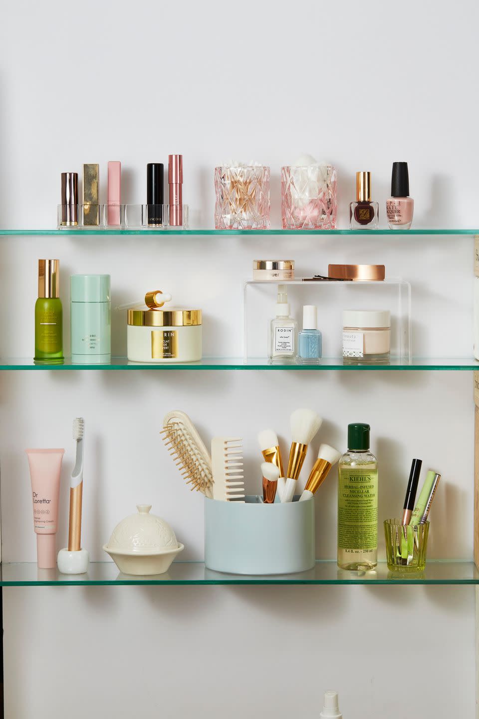 bathroom shelf ideas, makeup cabinet with products on clear shelves
